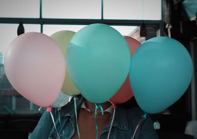 Person covered with colorful balloons