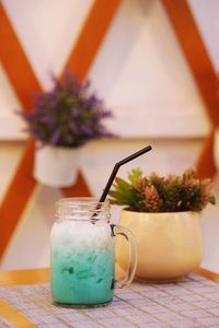 Close-up of drink in vase on table