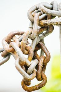 Close-up of rusty chain against sky