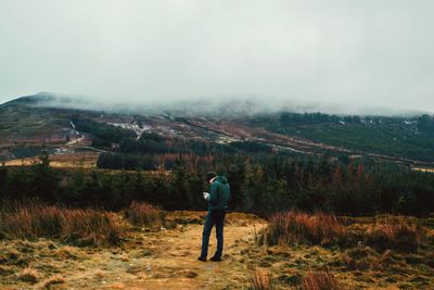 Rear view of man standing on land