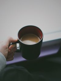 Close-up of hand holding coffee cup