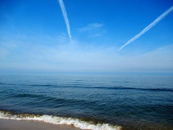 Scenic view of sea against blue sky