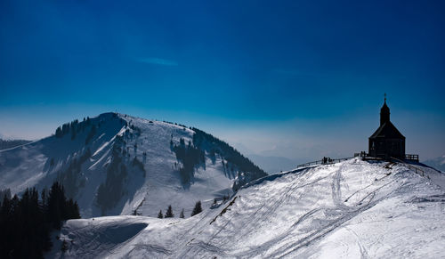 Scenic view of snow covered mountains against sky