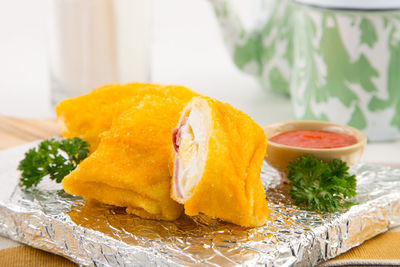 Close-up of food on foil plate at table