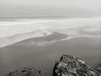 High angle view of rocks on sea shore