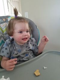 Portrait of cute baby boy sitting in highchair at home blue eyes.so cute smiling happy 