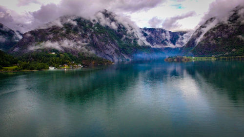 Scenic view of lake and mountains against sky