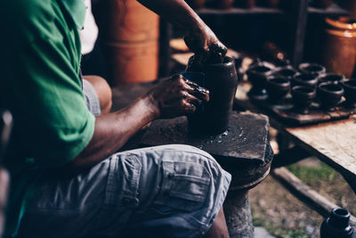 Midsection of man working at workshop