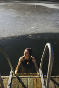 Woman swimming in lake at winter