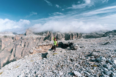 Panoramic shot of people on rock against sky