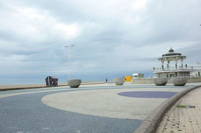 Road by sea against sky in city