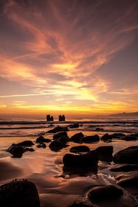 Scenic view of sea against romantic sky at sunset