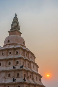 Low angle view of building against sky during sunset