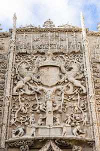 Low angle view of buddha statue against sky