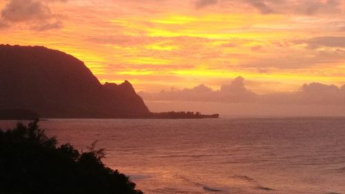 Scenic view of sea against orange sky