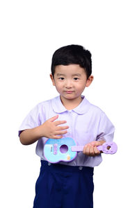 Portrait of cute boy standing against white background