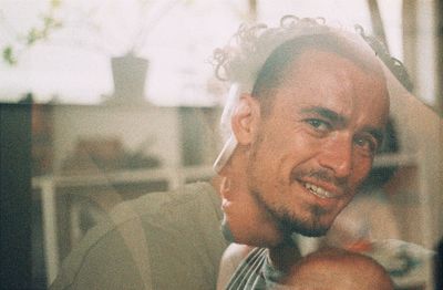 Close-up portrait of a smiling young man looking away