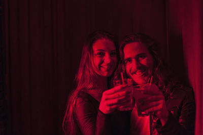 Couple sharing a drink in a night club