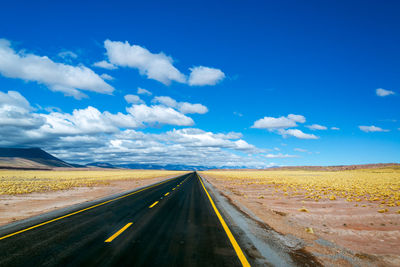 Empty road against sky at desert
