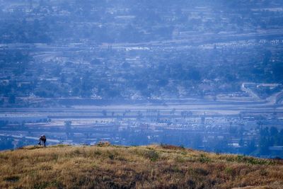 Man looking at landscape against sky