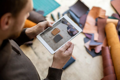 High angle view of people photographing on table