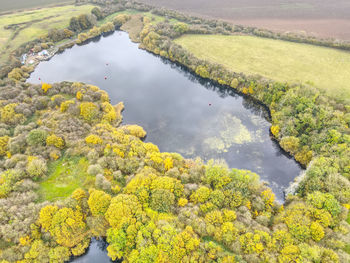 Drone photos of a lake and forest in east yorkshire, uk. autumn colours and stunning sky reflections