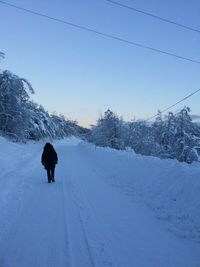 People standing on snow covered landscape