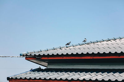 Low angle view of roof of building against clear sky