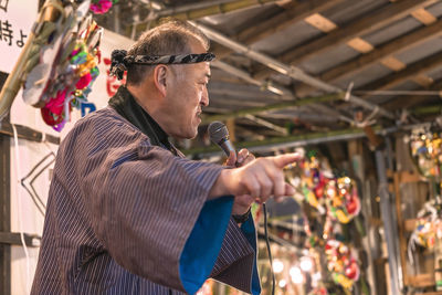 Side view of a man with umbrella