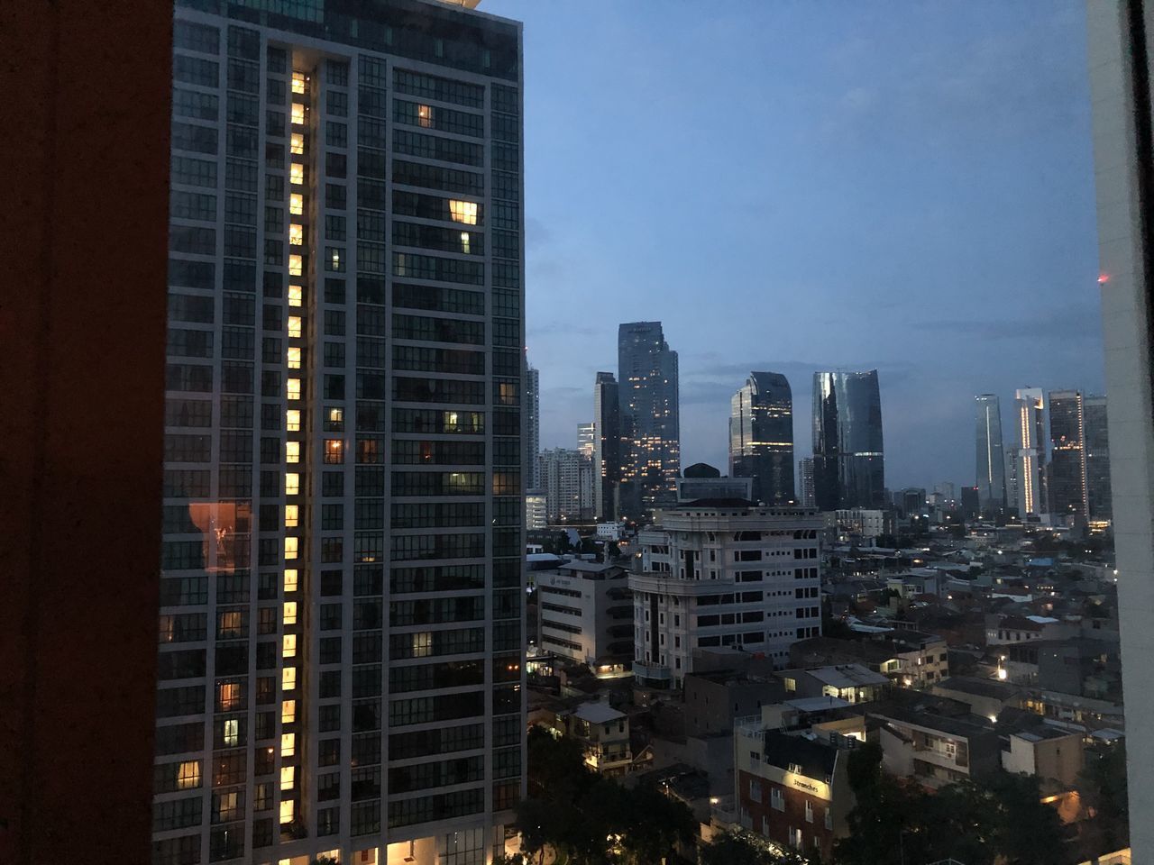 AERIAL VIEW OF ILLUMINATED BUILDINGS IN CITY