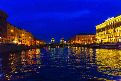 Illuminated buildings with waterfront at night