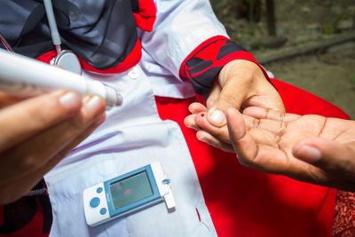 Midsection of couple holding hands