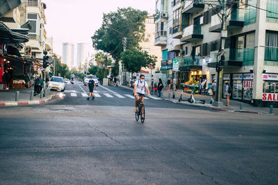 People riding bicycle on city street