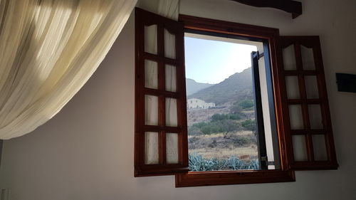 Scenic view of mountains seen through window