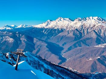 Scenic view of snowcapped mountains against clear blue sky