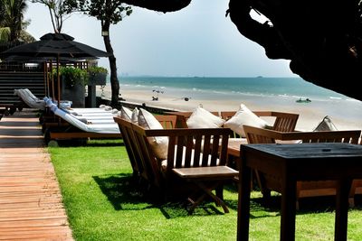 Empty chairs and tables at seaside