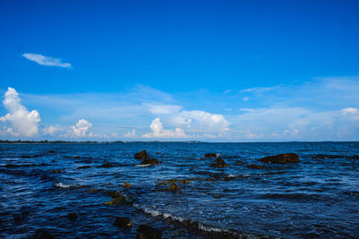 Scenic view of sea against blue sky