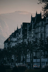 Buildings against sky at sunset