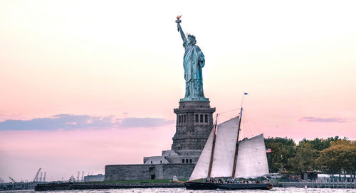 Statue of liberty against sky during sunset