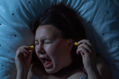 Close-up portrait of a girl lying on bed