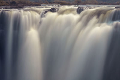 Close-up of water flowing over sea