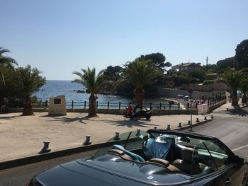 Swimming pool by sea against clear sky