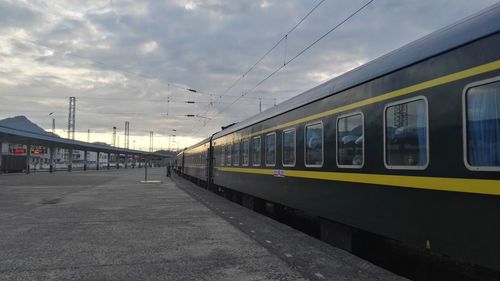 Train at railroad station against sky