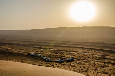 Scenic view of desert against sky during sunset