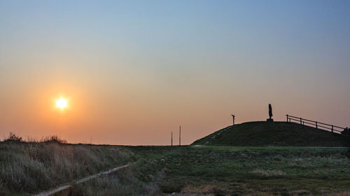 Scenic view of field against sky during sunset