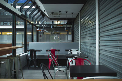 Empty chairs and tables in restaurant