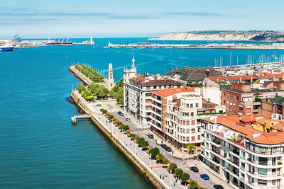 High angle view of buildings by sea against sky