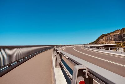 View of road against clear blue sky