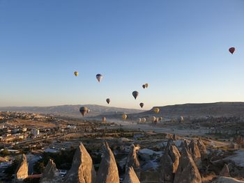 View of hot air balloons flying in city