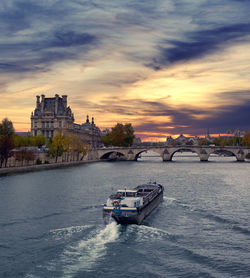 View of bridge over river against cloudy sky